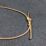 Rough amethyst cluster pendant in a brown cord net — VoxArcana