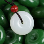 White jade-look donut pendant on a braided cord, 25 mm — VoxArcana