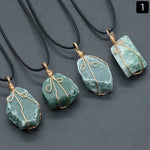 Raw green stone pendant wrapped in gold-tone wire, on black cord — VoxArcana