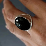 Black oval stone ring, open-work band, silver tone, size 6 — VoxArcana