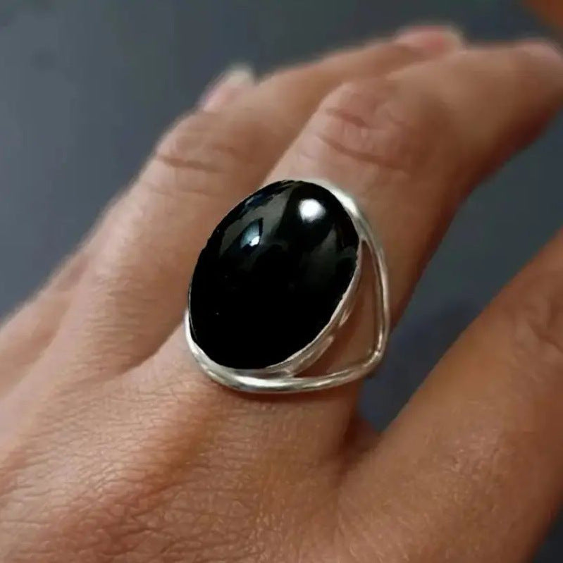 Black oval stone ring, open-work band, silver tone, size 6 — VoxArcana
