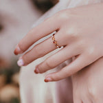 Three orange stone ring on a fine gold-tone band — VoxArcana